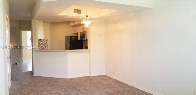 a kitchen with stainless steel appliances granite countertop a stove and a refrigerator
