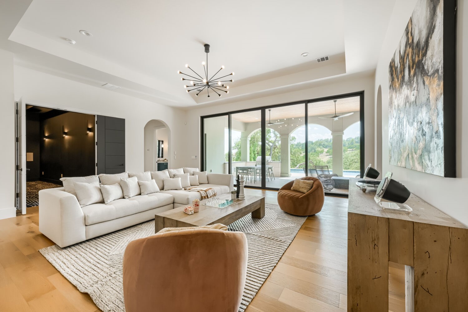 8132 Magnolia Ridge Cove Austin, TX 78738 - Photo 22 of 38 A luminous living area unfolds with rich wood floors and expansive sliding glass doors opening to the outdoors.