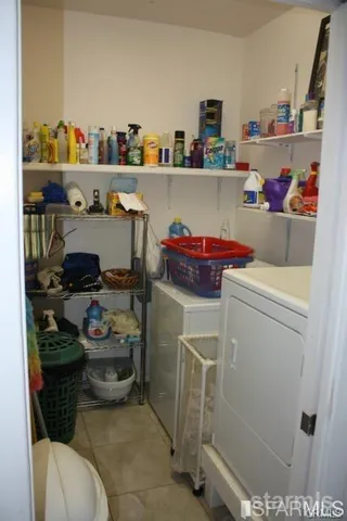 a utility room with sink dryer and washer