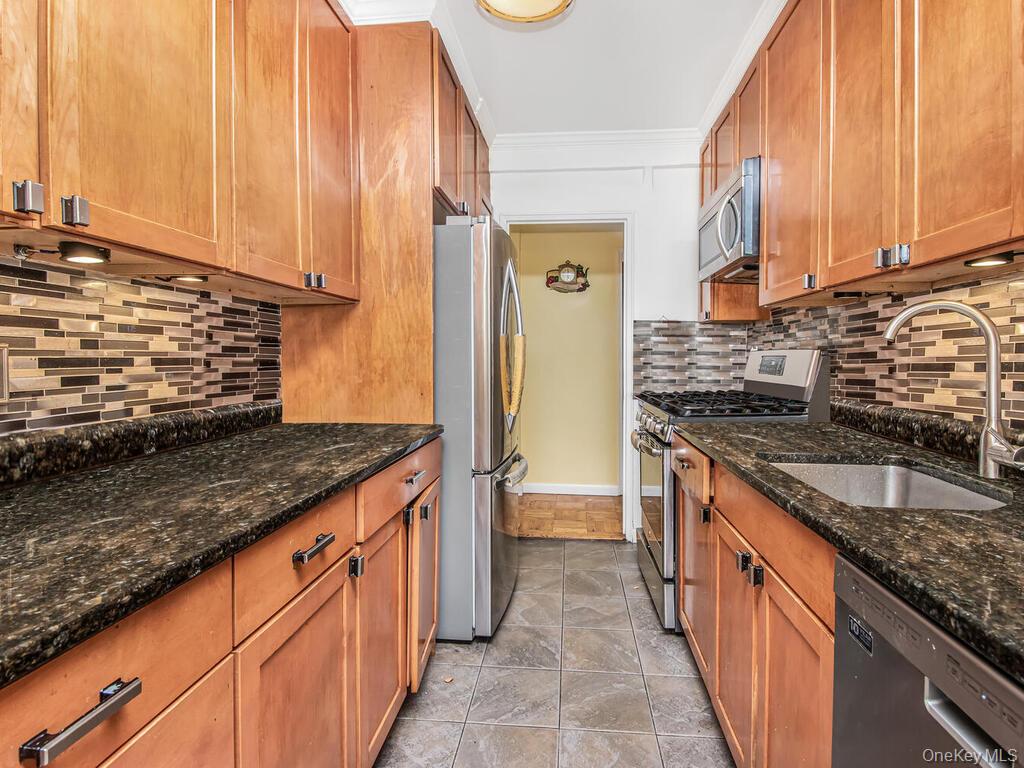 5500 Fieldston Road, Unit 5AA Bronx, NY 10471 - Photo 3 of 14 a kitchen with stainless steel appliances granite countertop a sink and a stove