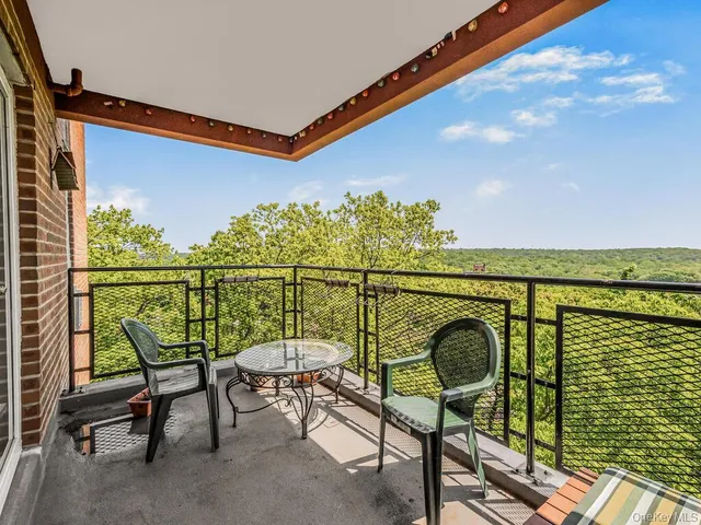 a view of a chairs and table in the balcony