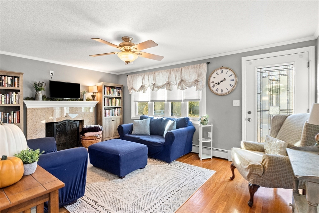 35 Memorial Drive Methuen, MA 01844 - Photo 17 of 42 a living room with furniture a fireplace and a flat screen tv