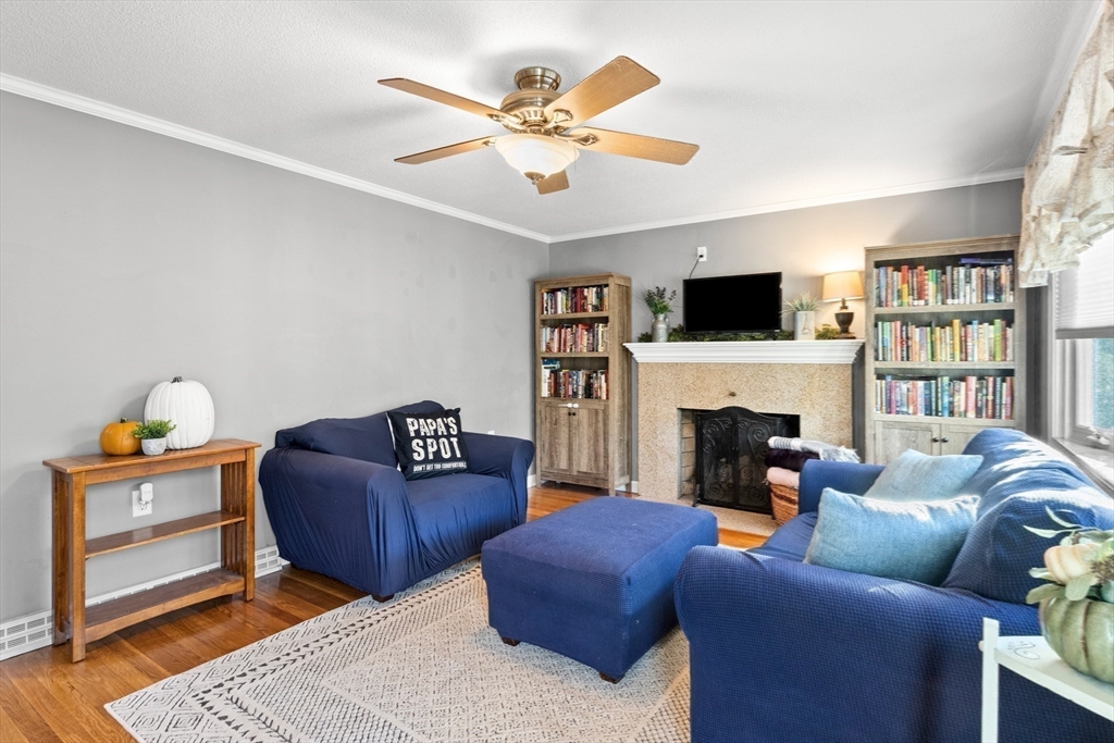 35 Memorial Drive Methuen, MA 01844 - Photo 18 of 42 a living room with furniture a flat screen tv and a fireplace