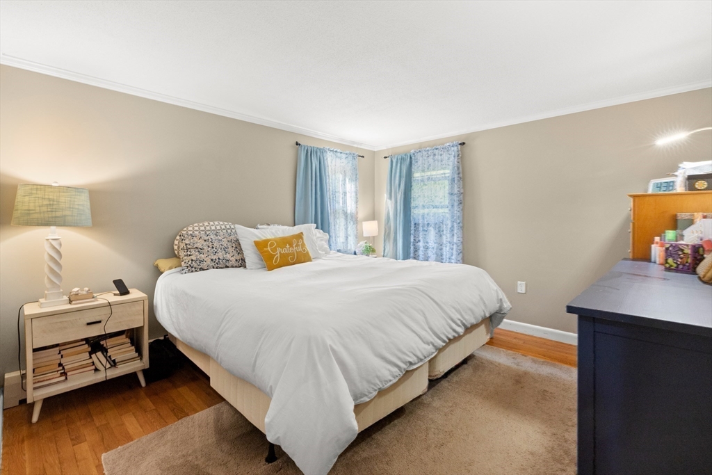 35 Memorial Drive Methuen, MA 01844 - Photo 24 of 42 a bedroom with a bed and wooden floor