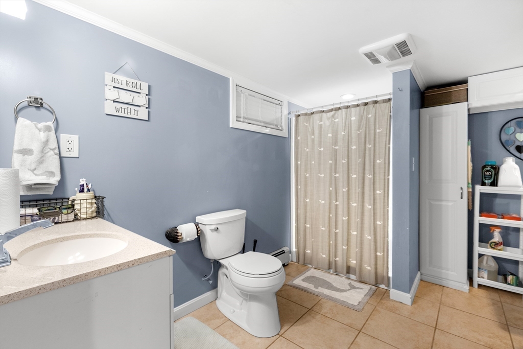 35 Memorial Drive Methuen, MA 01844 - Photo 28 of 42 a bathroom with a toilet a sink and a mirror