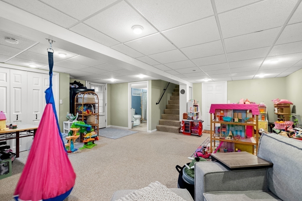 35 Memorial Drive Methuen, MA 01844 - Photo 32 of 42 a living room with a couch and toys