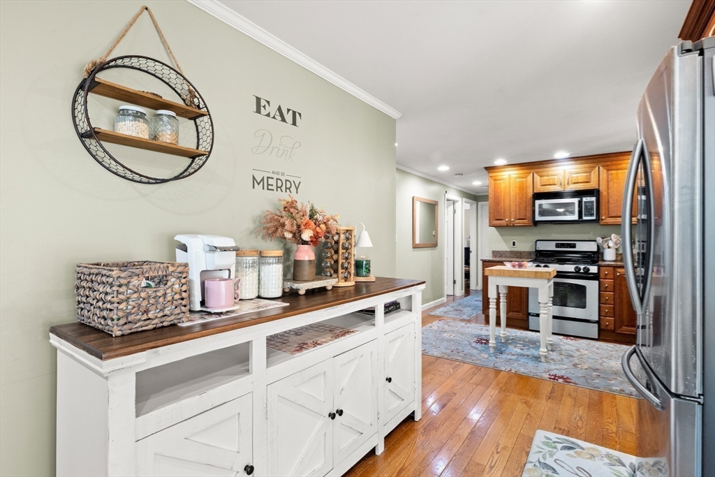35 Memorial Drive Methuen, MA 01844 - Photo 9 of 42 a kitchen with stainless steel appliances granite countertop a stove a sink and a wooden floors