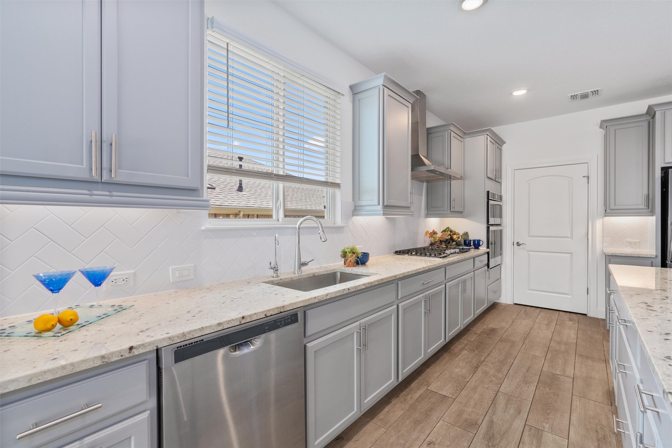 202 Spanish Star Street Georgetown, TX 78633 - Photo 11 of 32 a kitchen with granite countertop a sink stainless steel appliances and cabinets