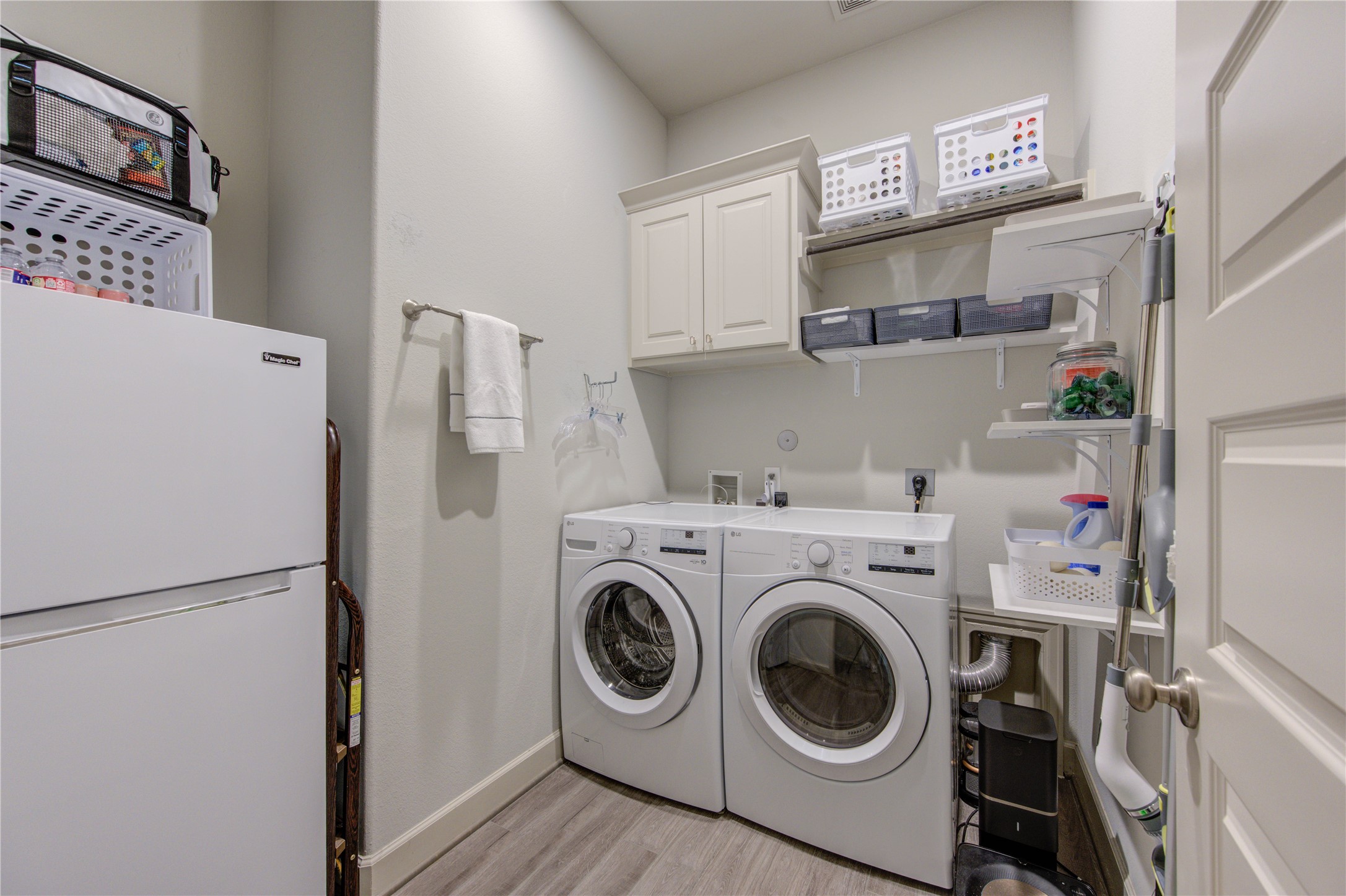 7326 Orangetip Road Katy, TX 77493 - Photo 27 of 43 Located just off the kitchen, this large laundry room offers both functionality and extra storage space. Designed for efficiency, it includes ample room for a washer and dryer, along with additional cabinetry for organization.