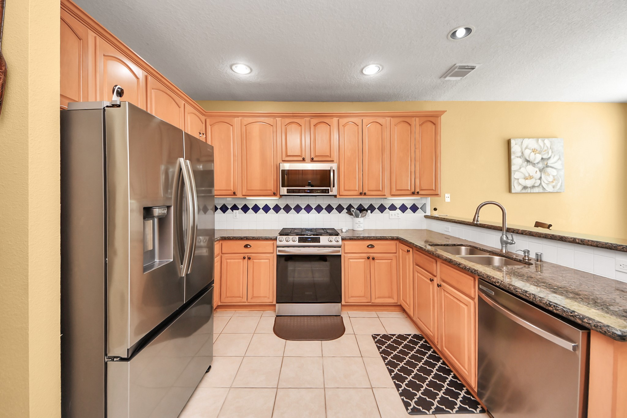 13635 Treebank Lane Houston, TX 77070 - Photo 6 of 26 a kitchen with stainless steel appliances granite countertop a refrigerator a sink and a stove