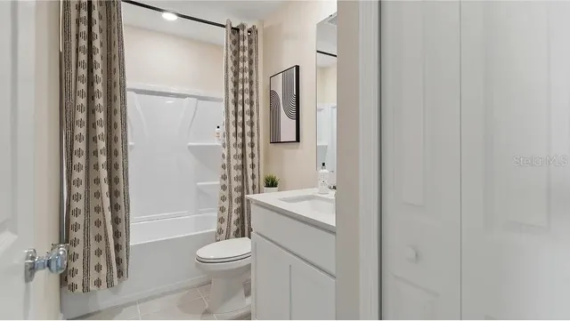 a bathroom with a toilet a sink and shower