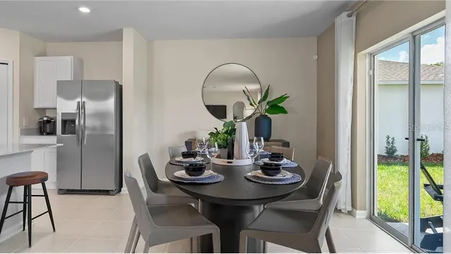 a view of a dining room with furniture a chandelier and wooden floor