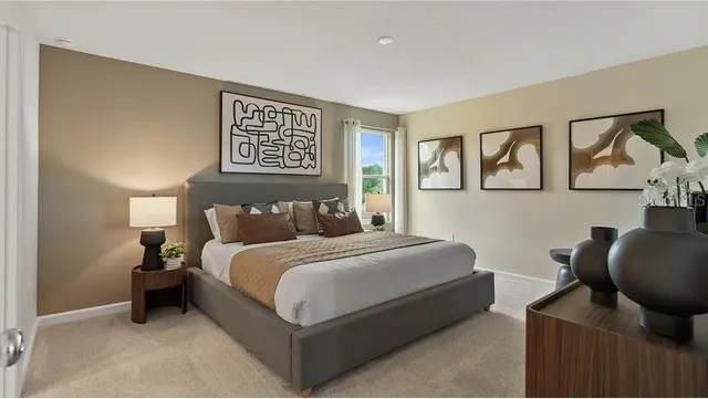 a bedroom with a bed and painting on the wall