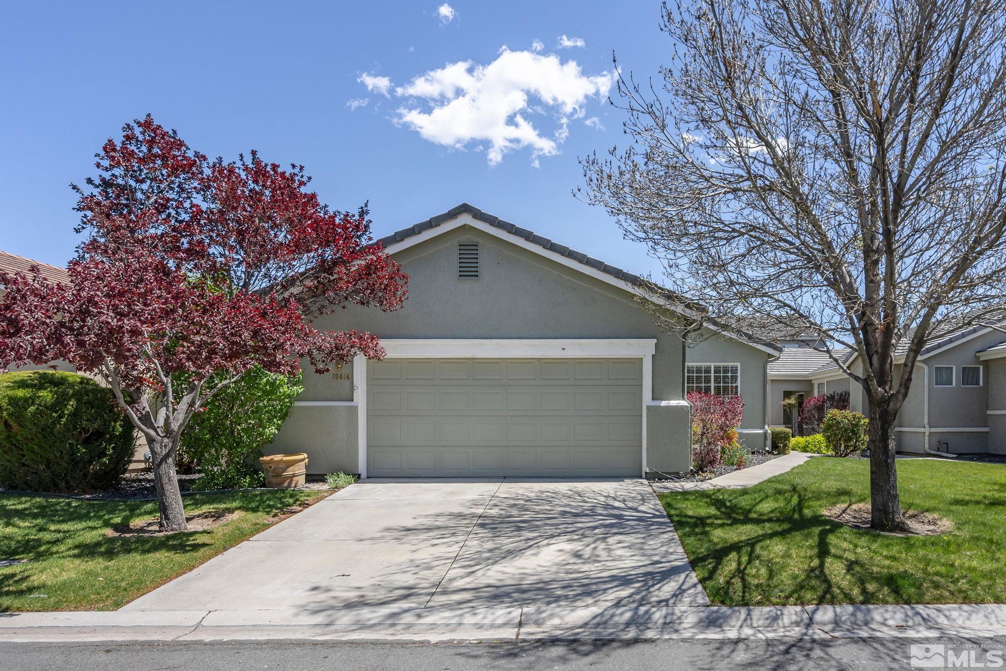 10414 Rockport Lane Reno, NV 89521 - Photo 21 of 22 a front view of a house with a yard and a garage