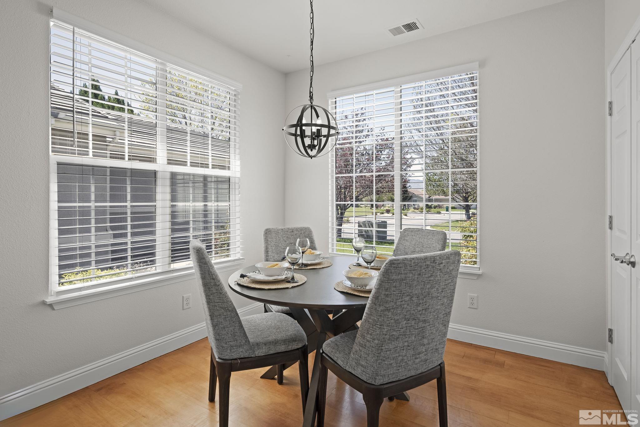 10414 Rockport Lane Reno, NV 89521 - Photo 10 of 22 a dining room with furniture large windows and wooden floor