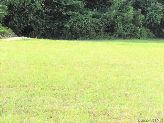 a view of beach and small yard