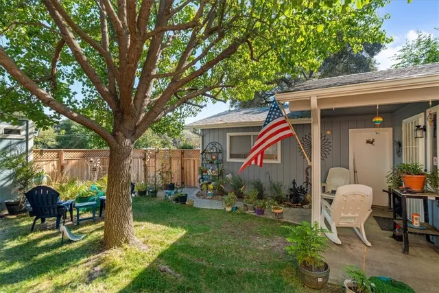 a view of backyard with a table and a chairs