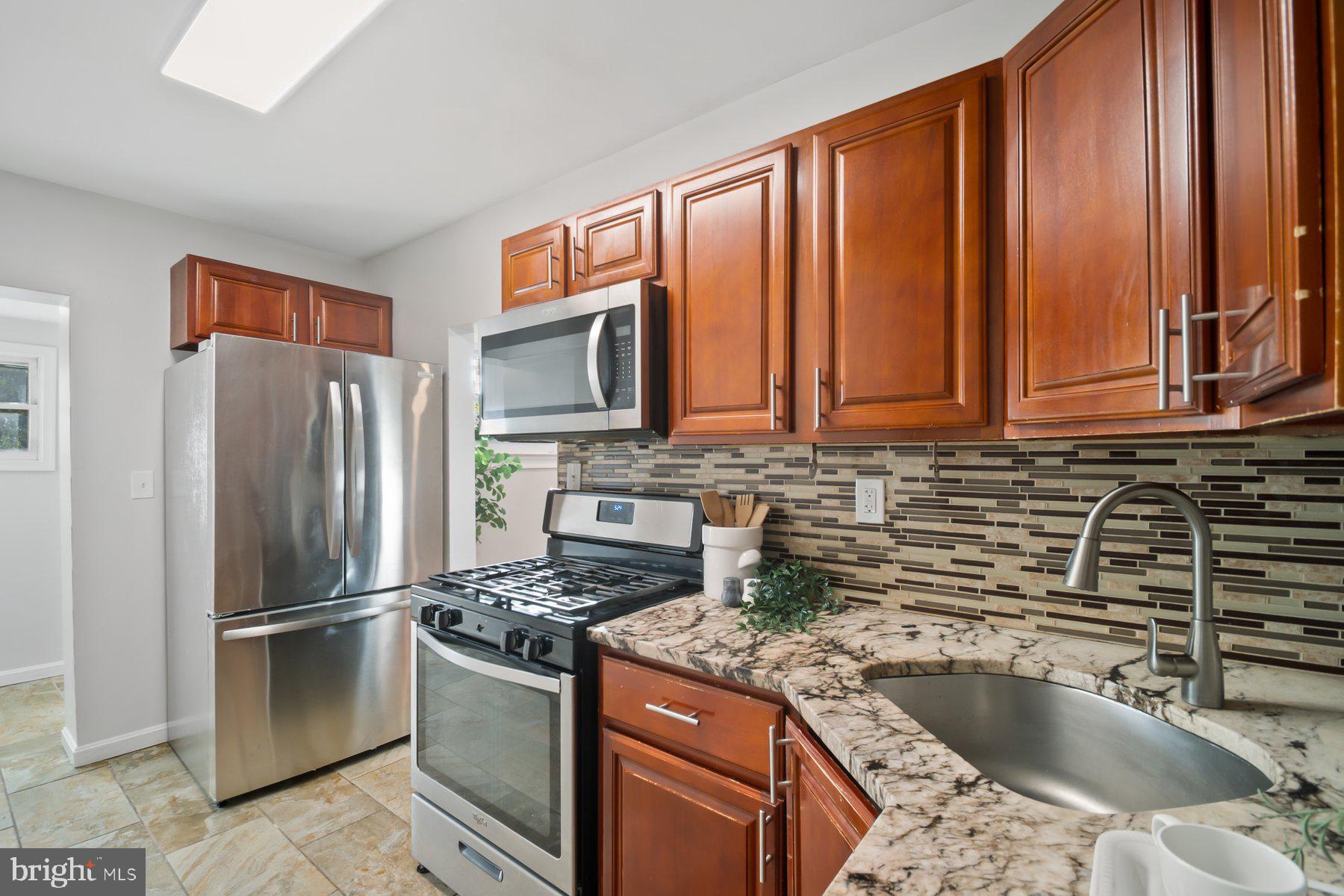 101 Willow Spring Road Dundalk, MD 21222 - Photo 12 of 28 a kitchen with stainless steel appliances granite countertop a refrigerator stove and sink