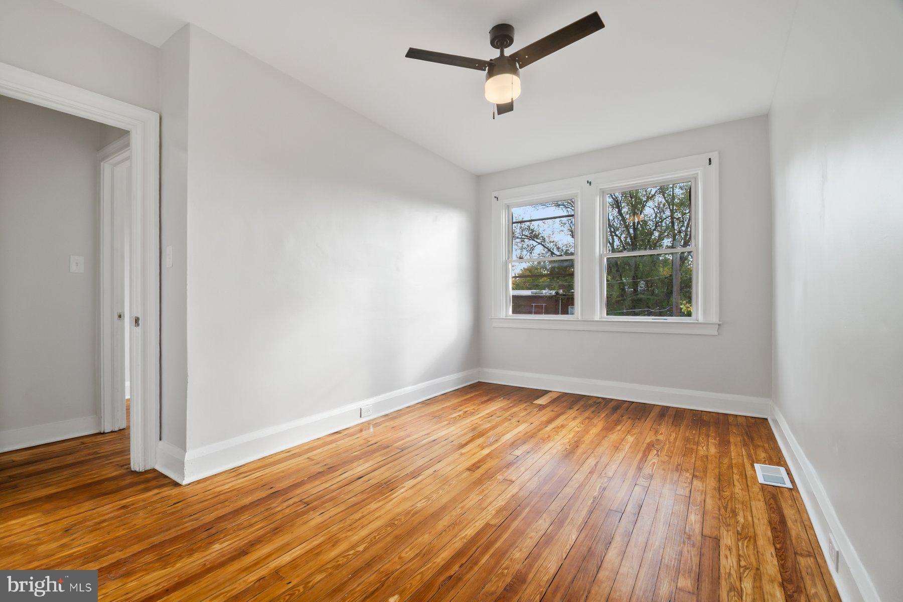 101 Willow Spring Road Dundalk, MD 21222 - Photo 16 of 28 a view of empty room with wooden floor and fan