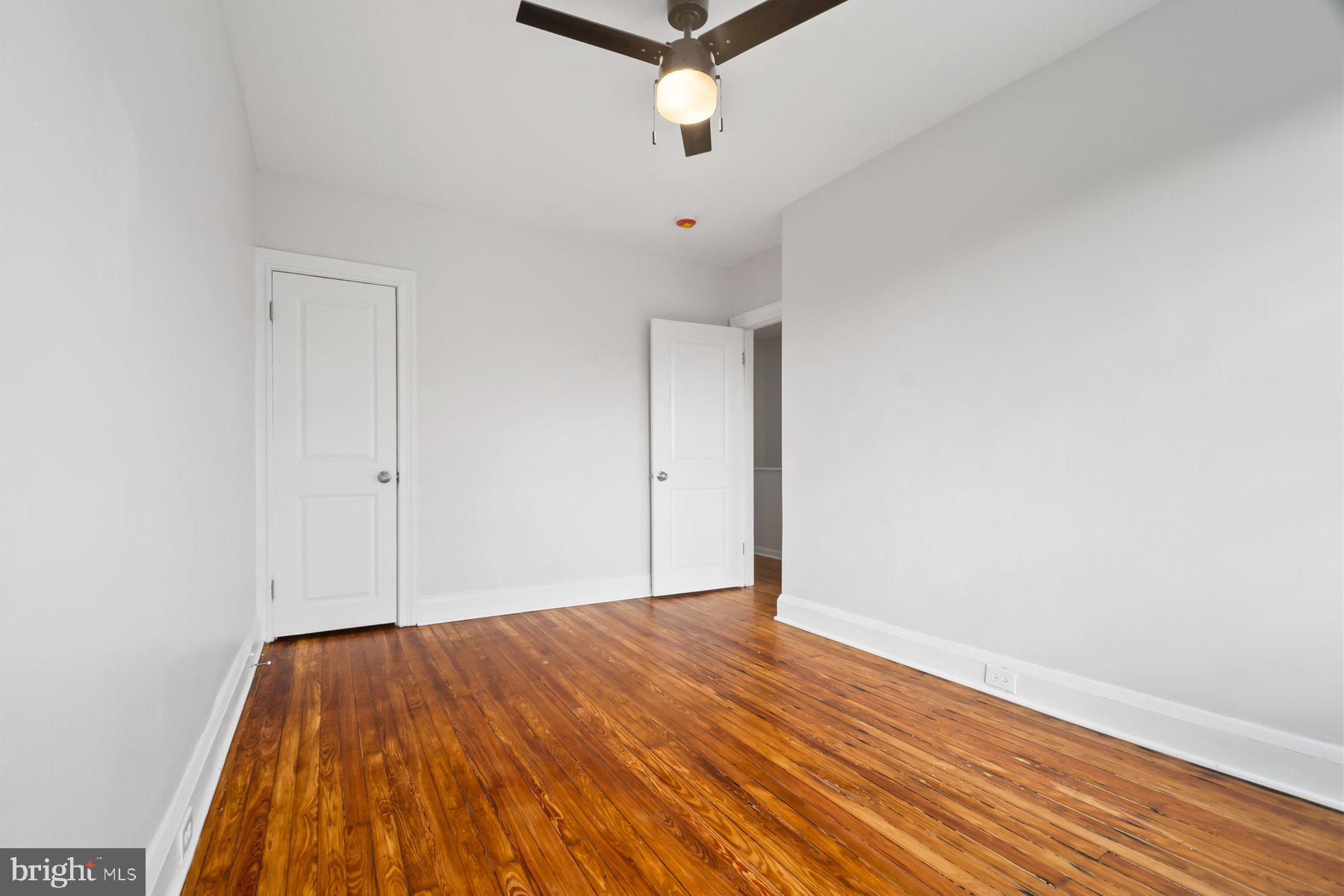 101 Willow Spring Road Dundalk, MD 21222 - Photo 17 of 28 a view of a room with wooden floor and a ceiling fan