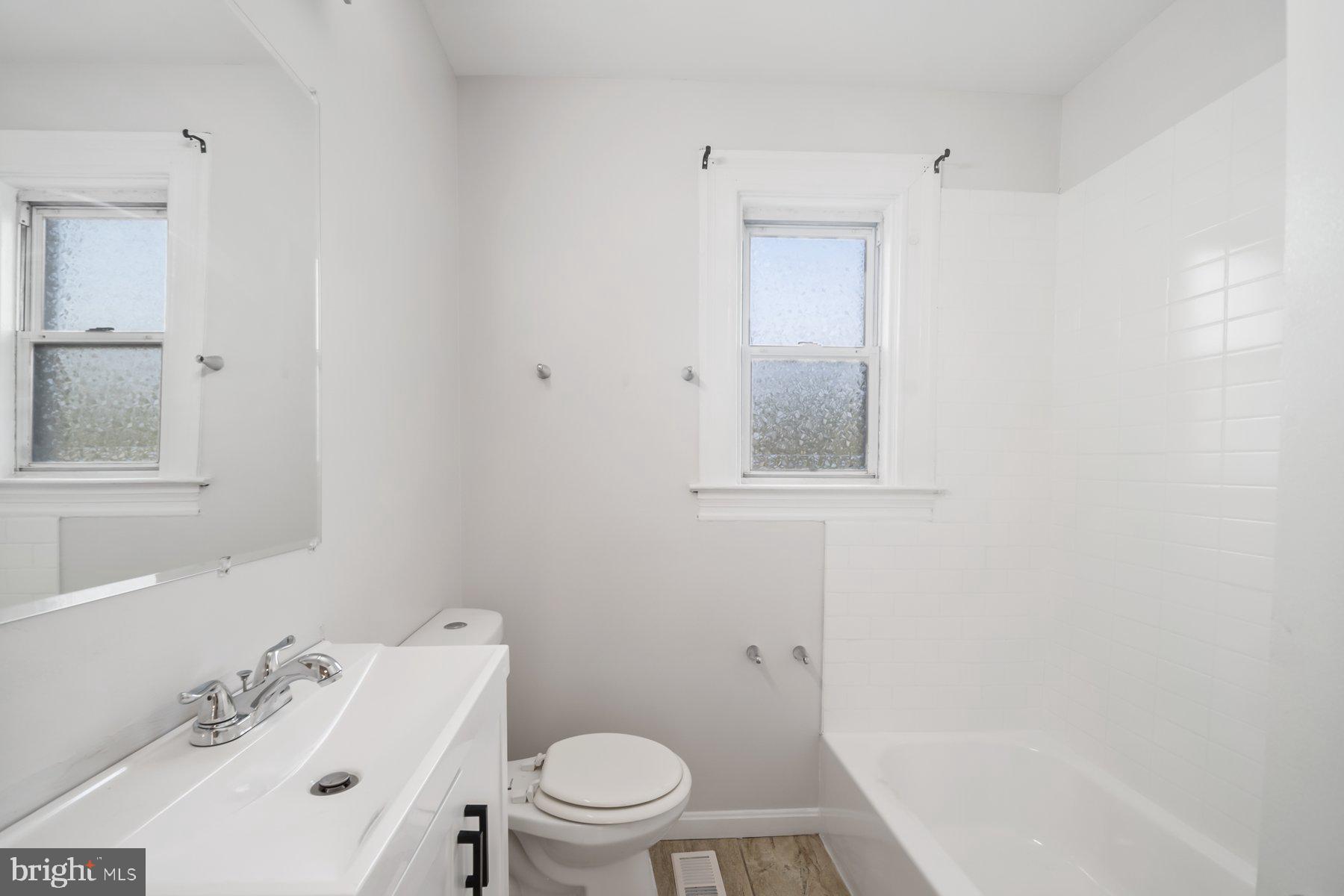 101 Willow Spring Road Dundalk, MD 21222 - Photo 18 of 28 a white toilet sitting next to a bathroom sink