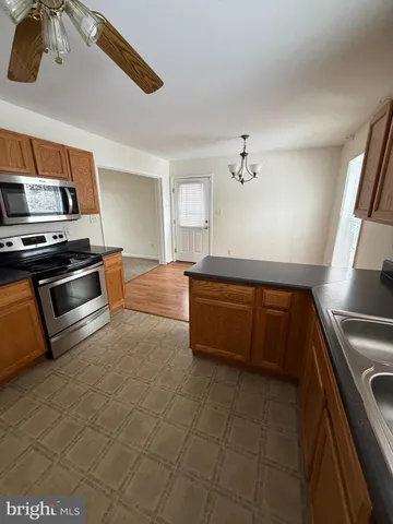 a kitchen with stainless steel appliances cabinets and a sink