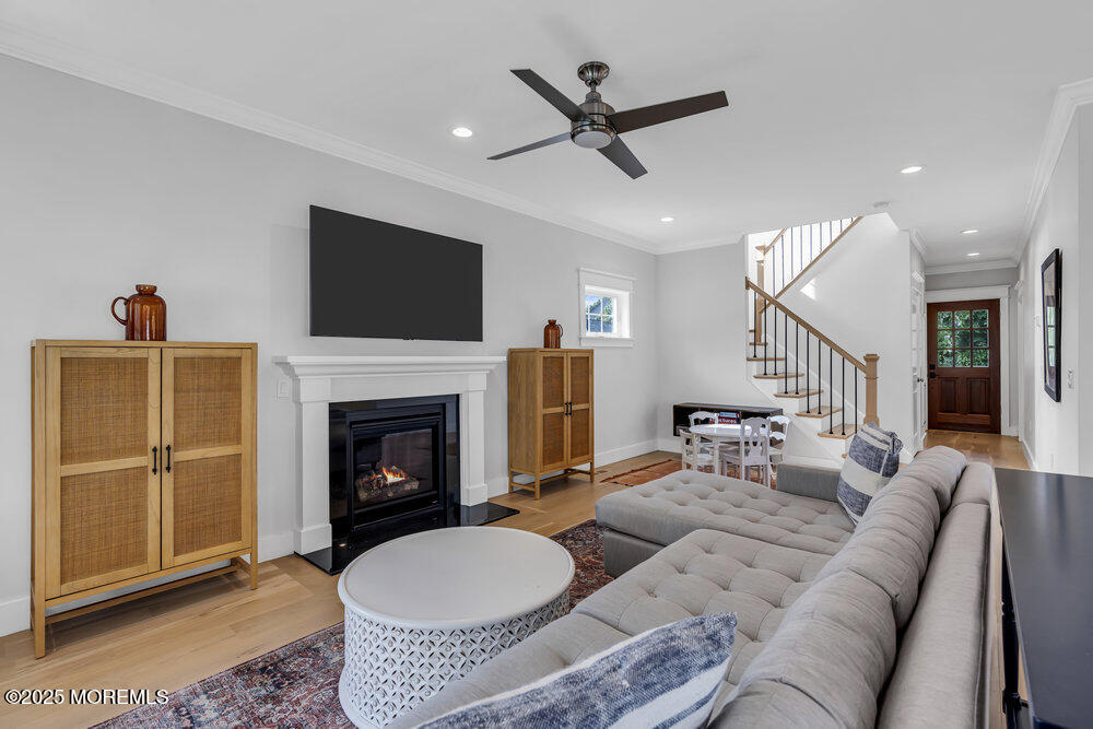 601 Ocean Road Spring Lake Heights, NJ 07762 - Photo 11 of 41 a living room with furniture a flat screen tv and a fireplace