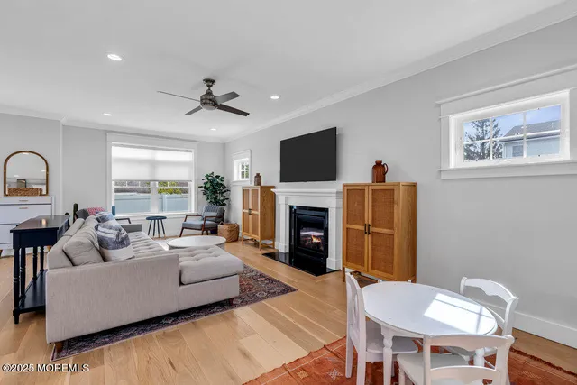 a living room with furniture a fireplace and a flat screen tv