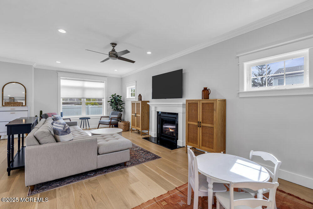 601 Ocean Road Spring Lake Heights, NJ 07762 - Photo 13 of 41 a living room with furniture a fireplace and a flat screen tv