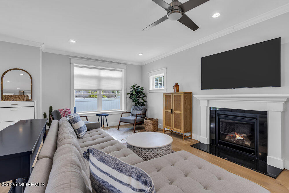 601 Ocean Road Spring Lake Heights, NJ 07762 - Photo 14 of 41 a living room with furniture a fireplace and a flat screen tv