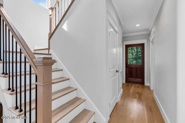 a view of a hallway with wooden floor and entryway