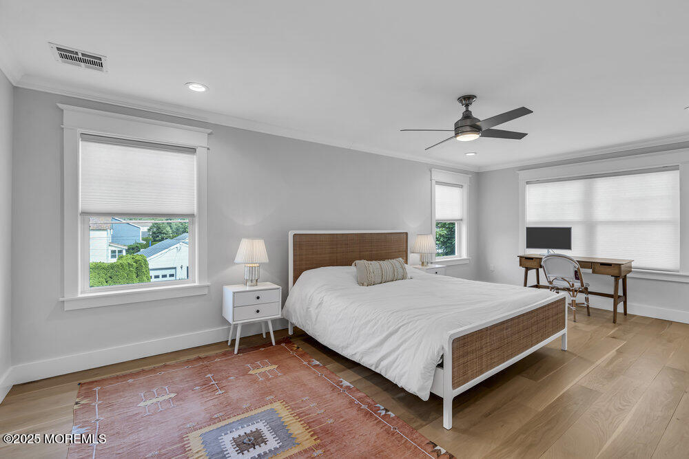 601 Ocean Road Spring Lake Heights, NJ 07762 - Photo 17 of 41 a bedroom with a bed a table and chair