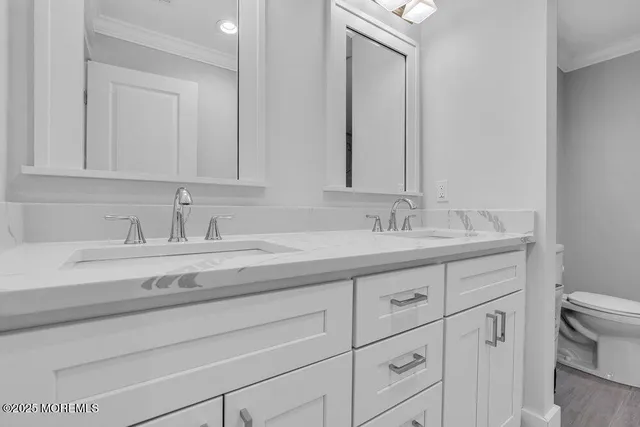 a bathroom with double sink and a mirror