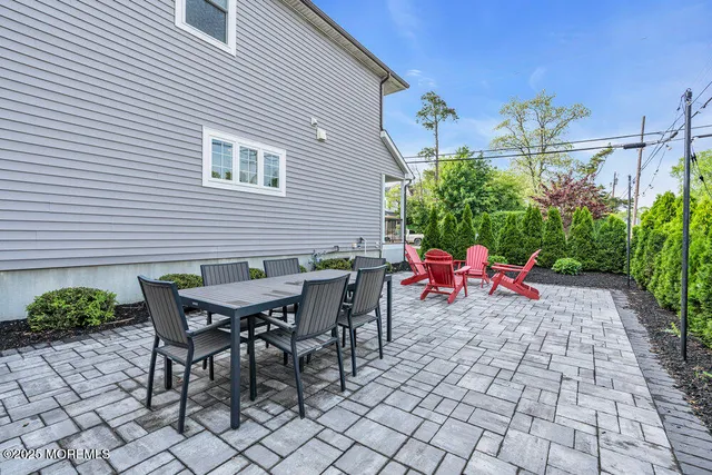 a view of a patio with table and chairs and potted plants