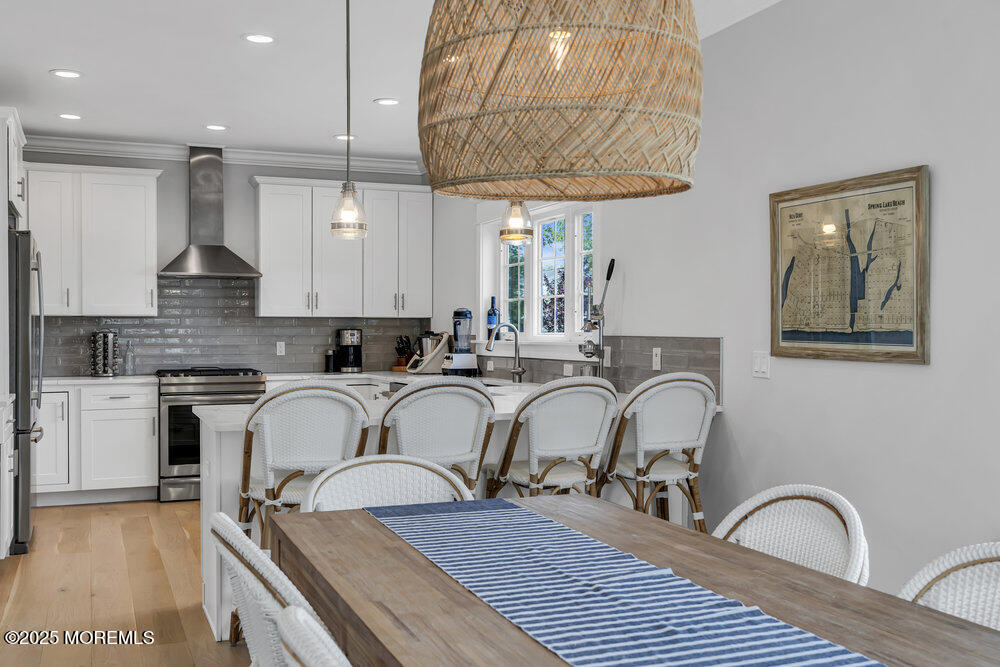 601 Ocean Road Spring Lake Heights, NJ 07762 - Photo 7 of 41 a kitchen with stainless steel appliances granite countertop a table chairs sink and cabinets