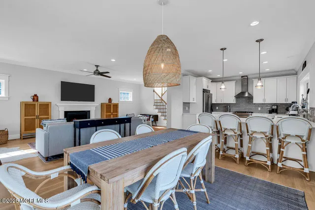 a dining room with furniture a large window and a chandelier
