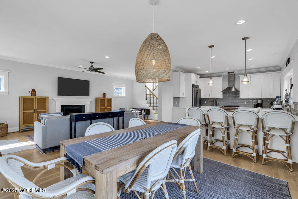 601 Ocean Road Spring Lake Heights, NJ 07762 - Photo 8 of 41 a dining room with furniture a large window and a chandelier
