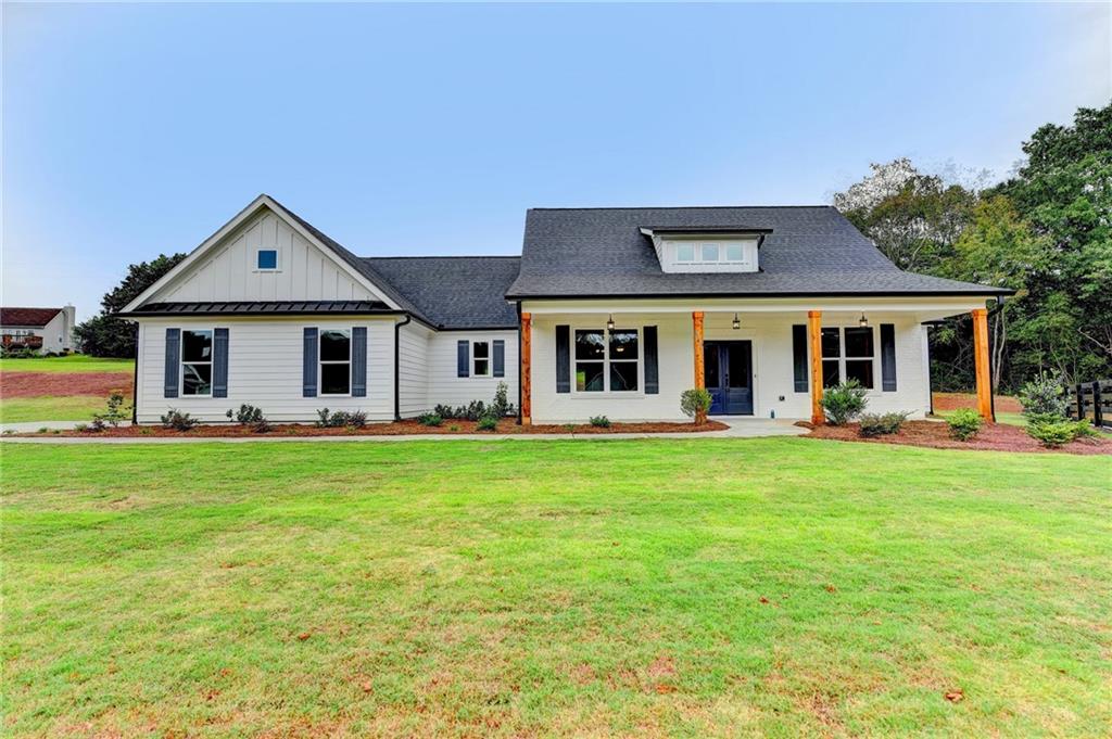 8895 Little Mill Road Cumming, GA 30041 - Photo 1 of 1 a front view of a house with a garden