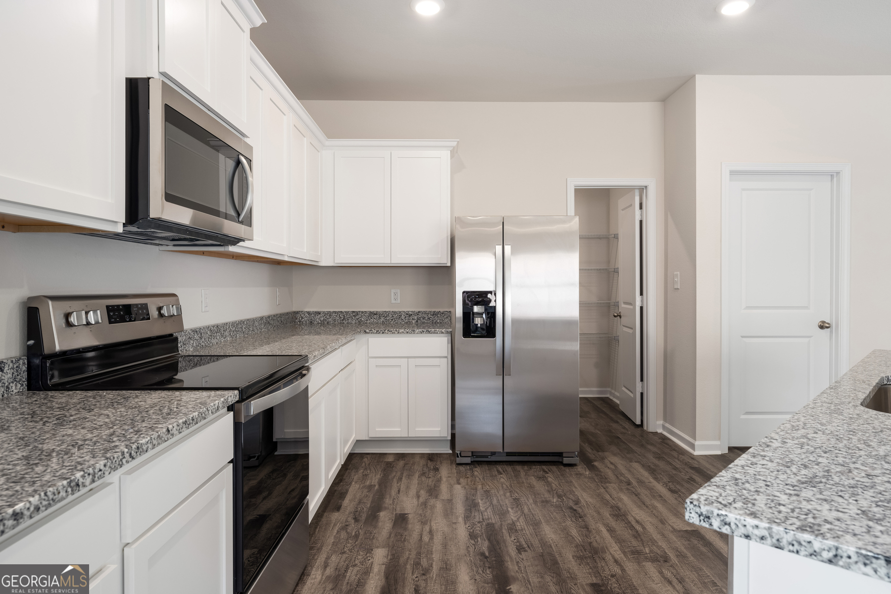 662 Mackenzie Cove Villa Rica, GA 30180 - Photo 7 of 13 a kitchen with stainless steel appliances granite countertop a refrigerator a stove and a sink