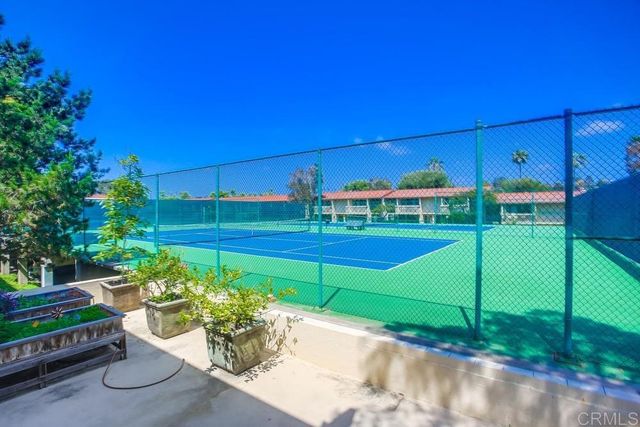 a view of a house with a small yard and wooden fence