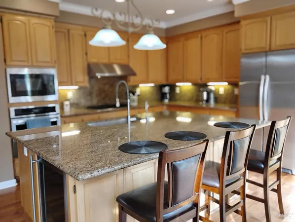 a kitchen with cabinets and chandelier