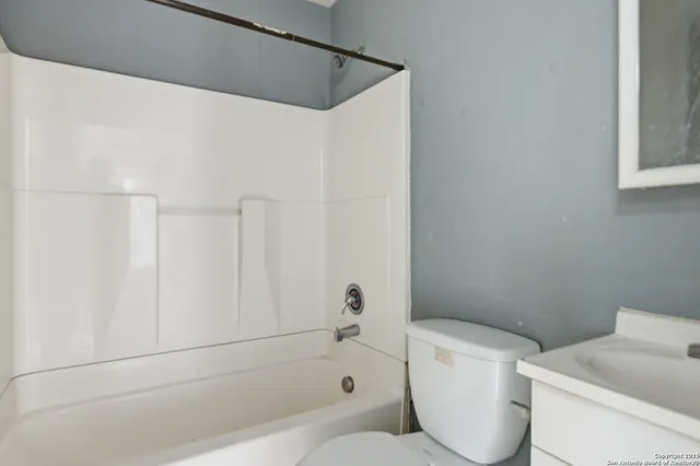 a bathroom with a toilet and a bathtub