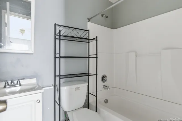 a bathroom with a toilet sink and shower