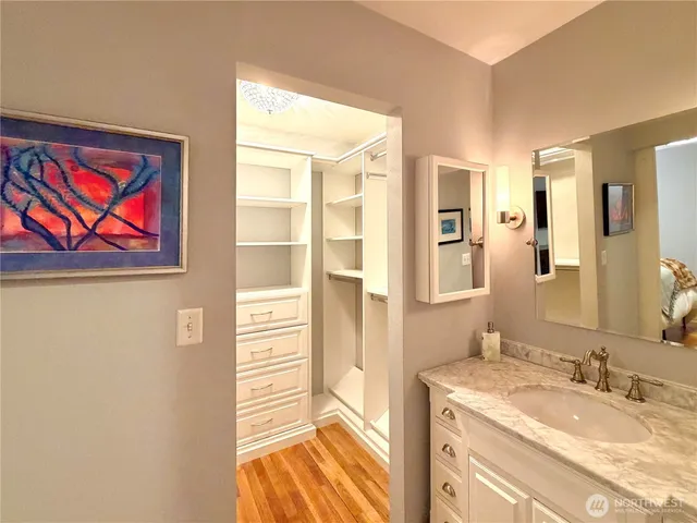 a bathroom with a granite countertop sink mirror and
