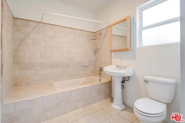 a bathroom with a sink a toilet and a bathtub