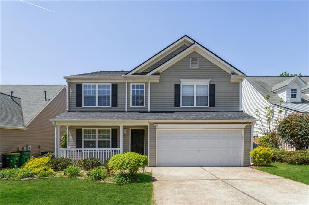 262 Weatherstone Pointe Drive Woodstock, GA 30188 - Photo 1 of 1 a front view of a house with garden