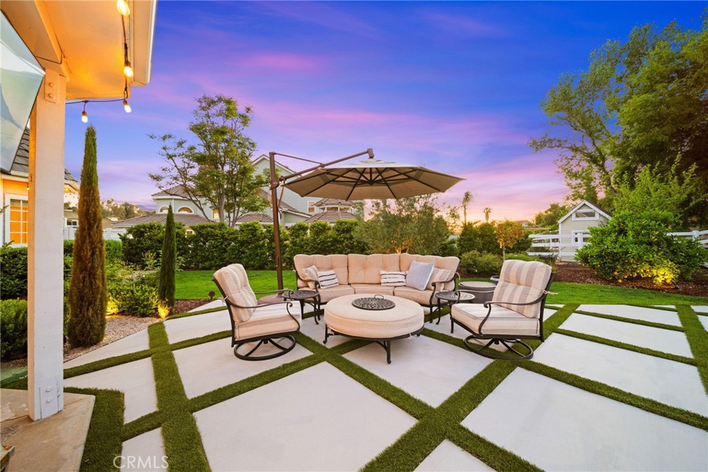 30702 Cll Pina Colada Temecula, CA 92591 - Photo 14 of 75 a view of a patio with a dining table and chairs with wooden floor