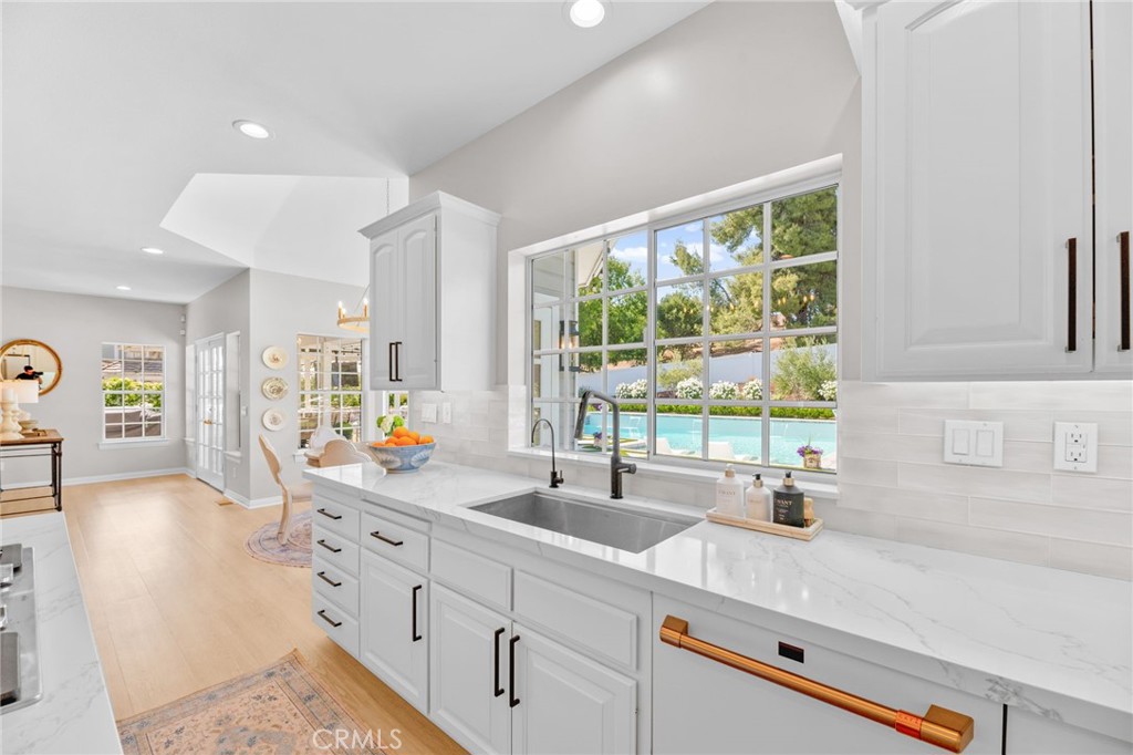 30702 Cll Pina Colada Temecula, CA 92591 - Photo 42 of 75 a kitchen with counter top space sink and living room