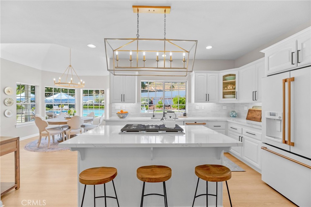 30702 Cll Pina Colada Temecula, CA 92591 - Photo 43 of 75 a kitchen with stainless steel appliances a table chairs and a refrigerator