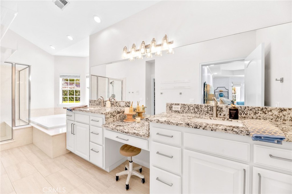 30702 Cll Pina Colada Temecula, CA 92591 - Photo 50 of 75 a bathroom with a sink vanity granite tub toilet and a mirror